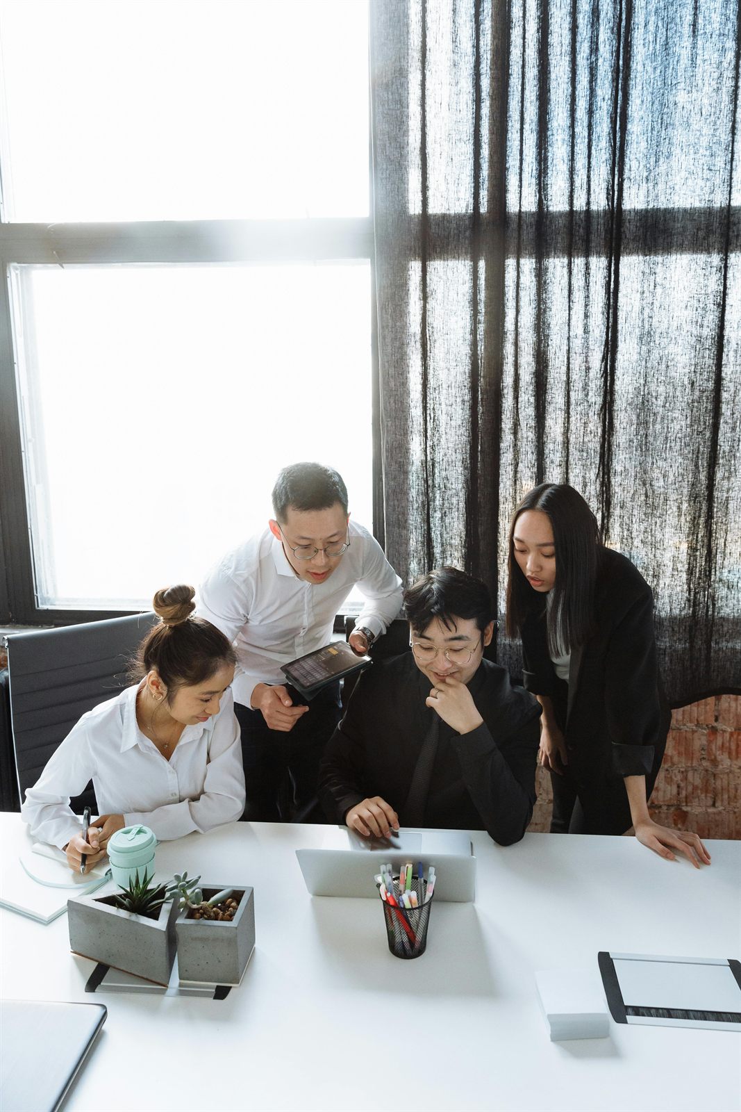 Business team reviewing work together on a laptop